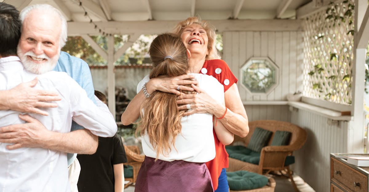 A heartwarming reunion with family members hugging and smiling in a cozy indoor setting.